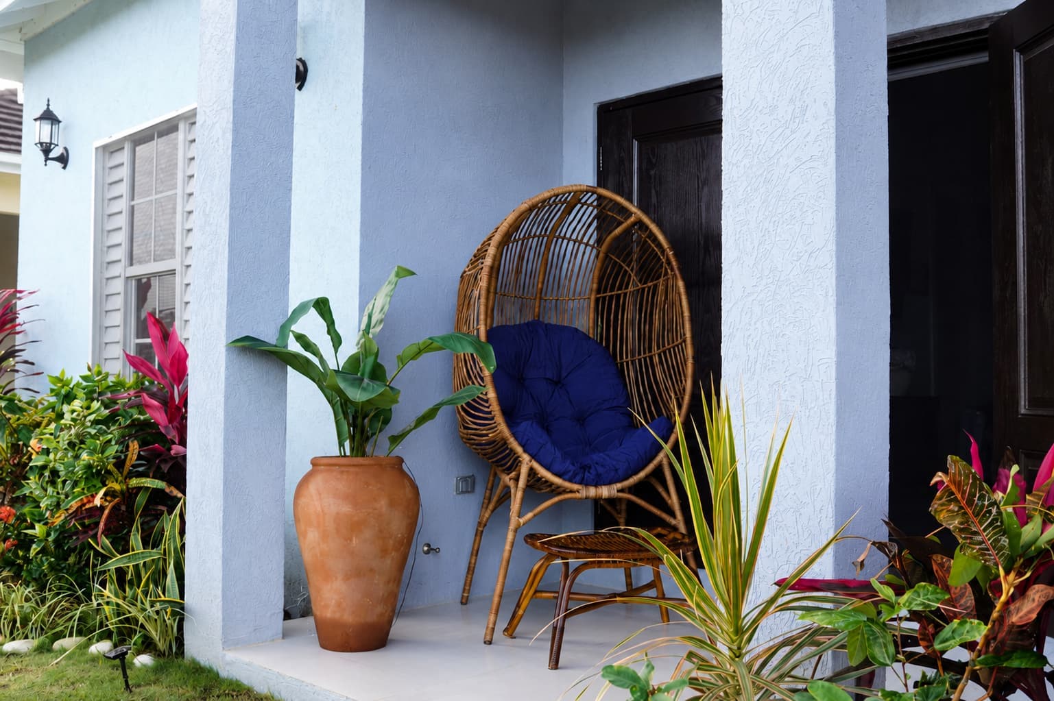 The welcoming front porch features a comfortable outdoor seating area perfect for enjoying the tropical breeze in St. Mary, Jamaica.
