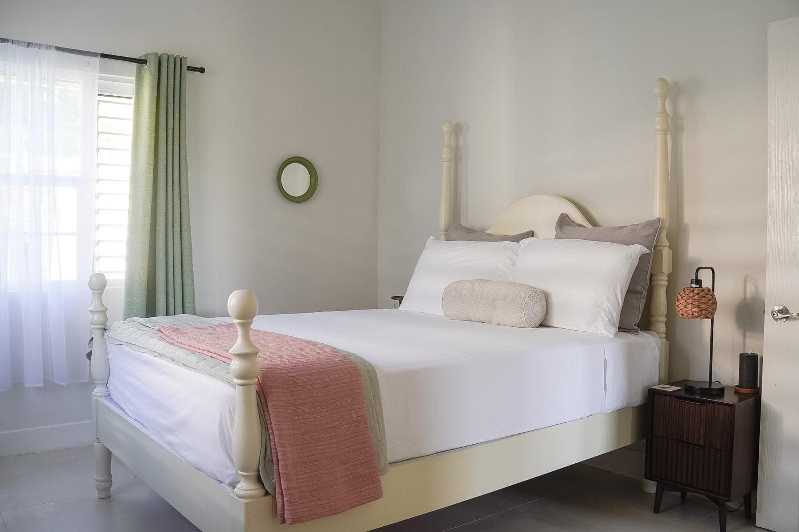The vibrant green room features a beautifully styled boutique bedroom suite designed for ultimate comfort during a St. Mary, Jamaica getaway.