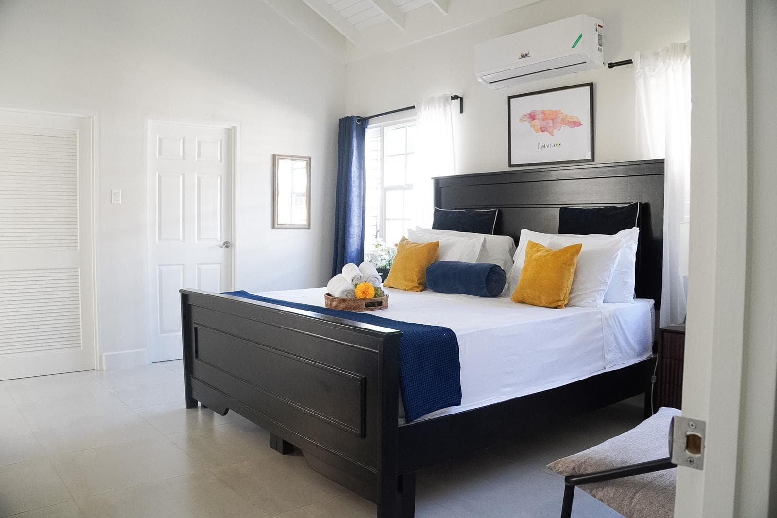 The luxury master bedroom suite comes complete with a plush king bed and direct access to fresh tropical breezes.